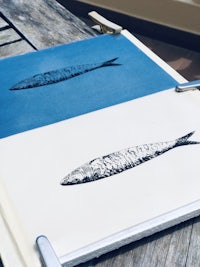 a blue and white print of a fish on a table